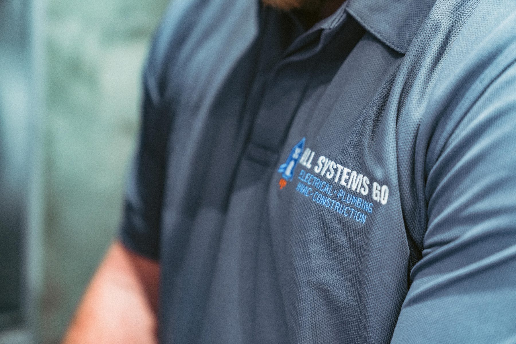 All Systems Go techs servicing a rooftop condenser in Utah County